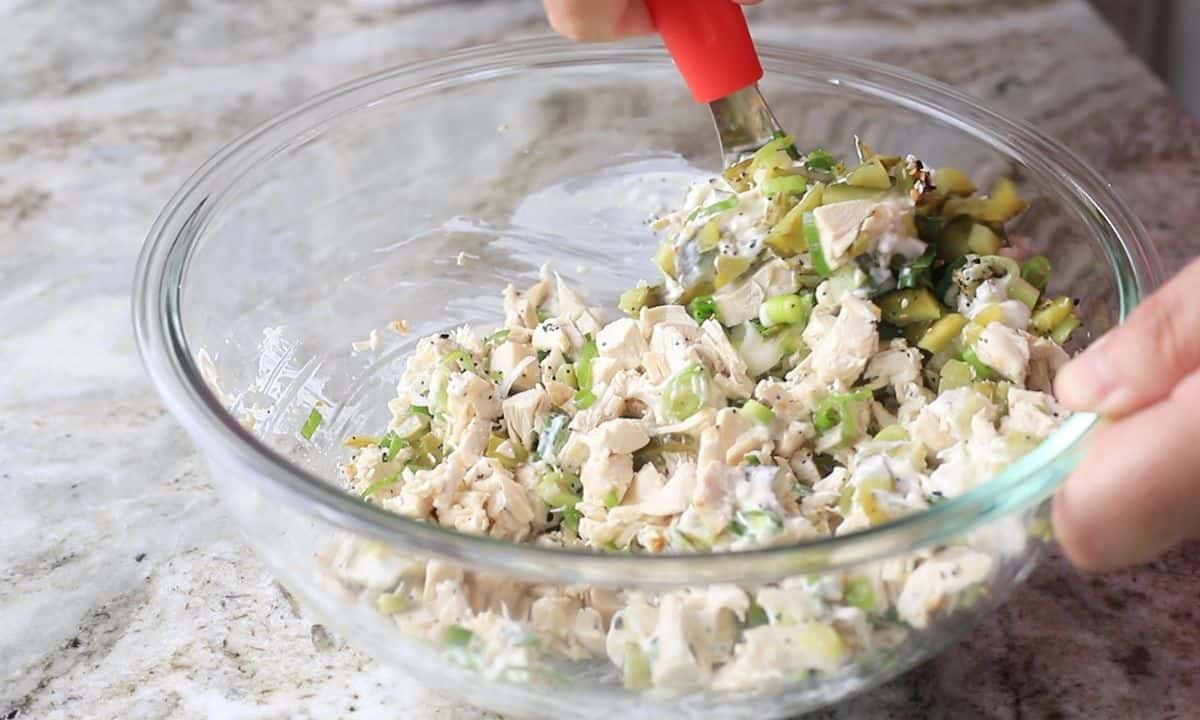 mixing the chicken salad.