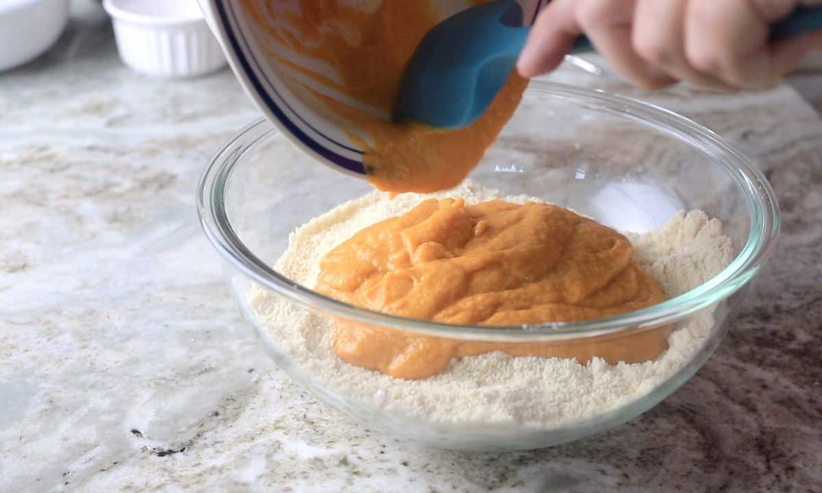 transferring the wet mixture into the dry mixture.