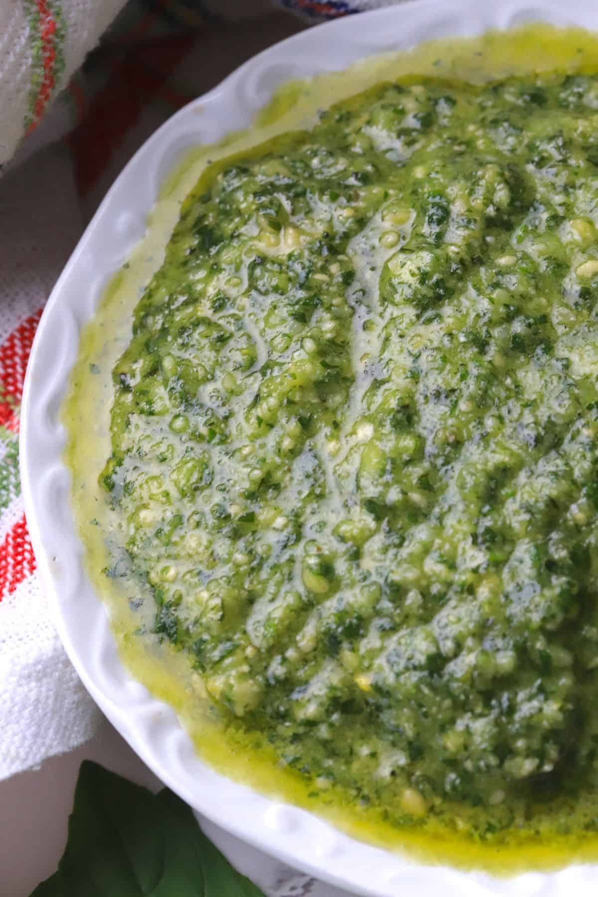 A small bowl of pesto di basilico.