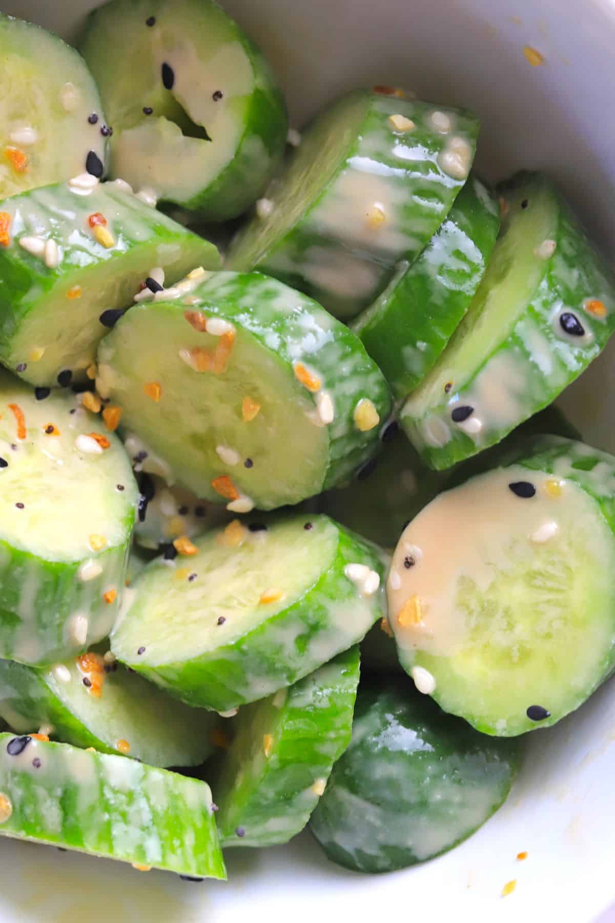 Bowl of cucumber salad mixed with the roasted sesame dressing.
