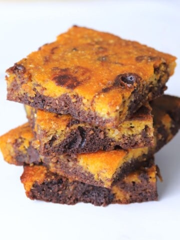 Four healthy pumpkin brownies stacked on top of each other.