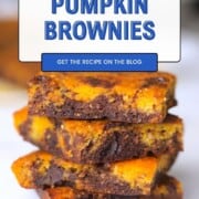 Four healthy pumpkin brownies stacked on top of each other.