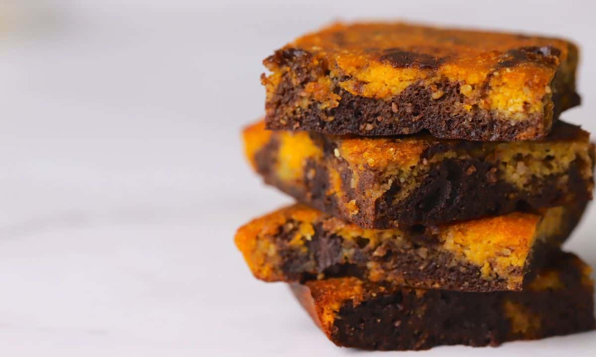 Four healthy pumpkin brownies stacked on top of each other.