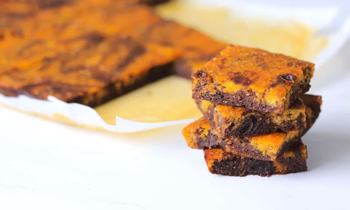 Four healthy pumpkin brownies stacked on top of each other.