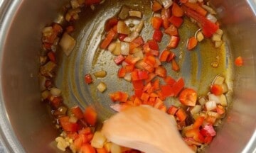 Stirring the red peppers and onions in the soup pot.