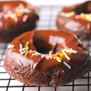 Chocolate sugar free collagen donuts on a wire rack.