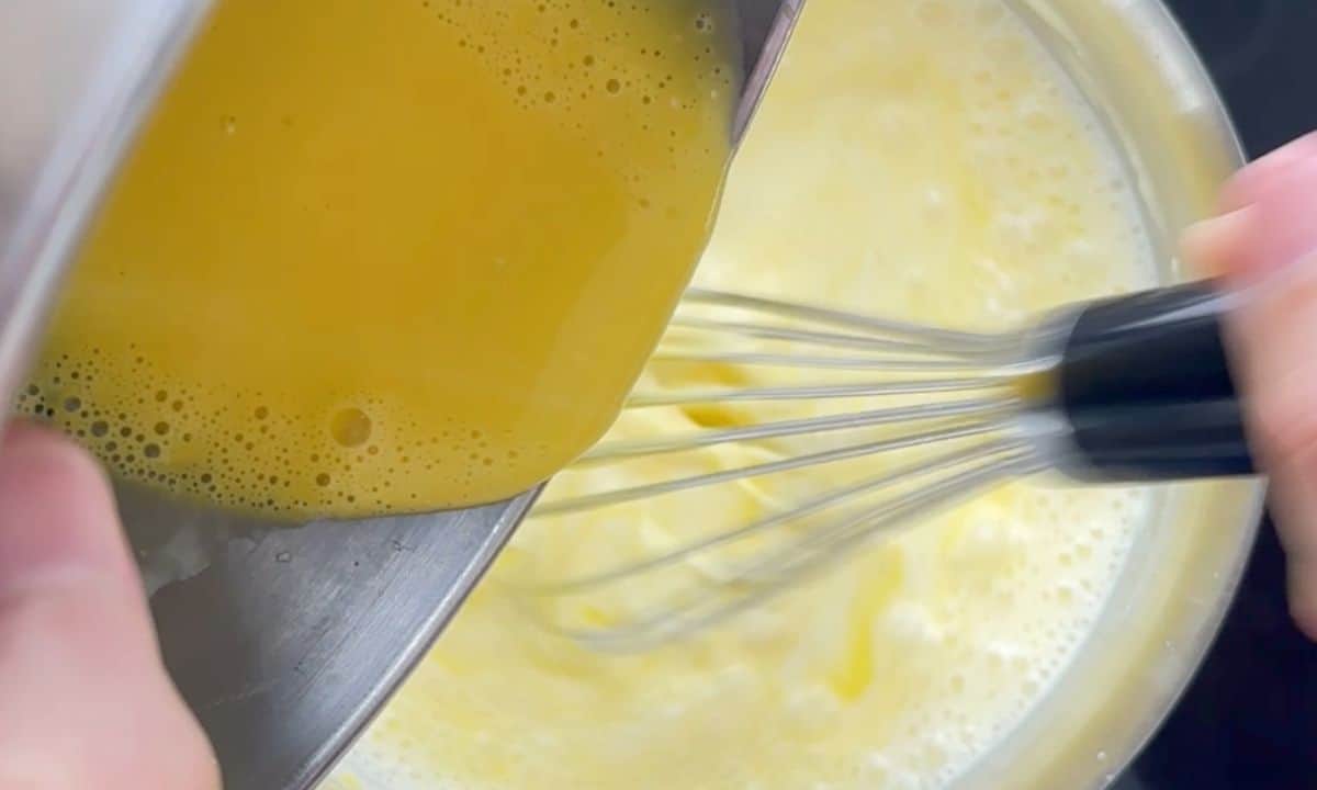 Whisking in the egg yolks to the bechamel keto sauce.