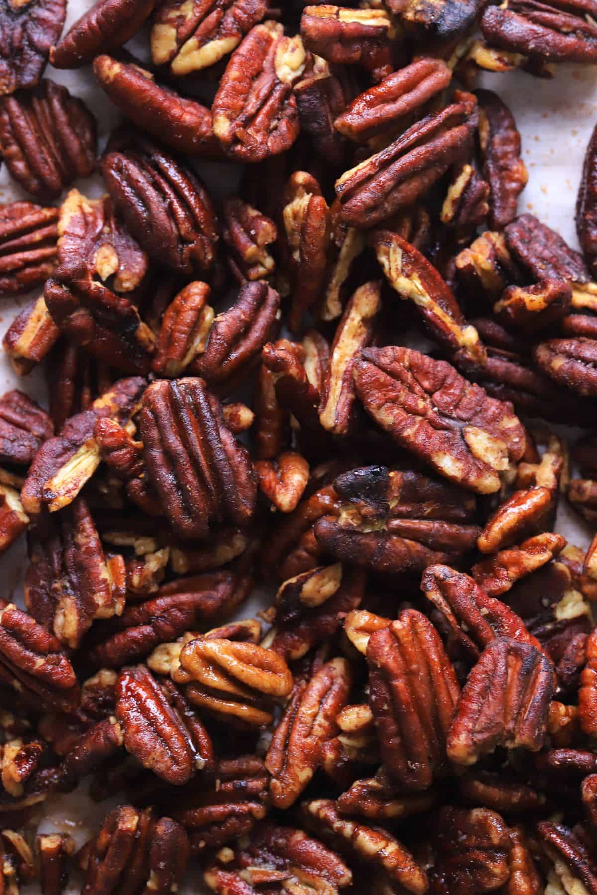 Low carb candied pecans on a baking sheet.