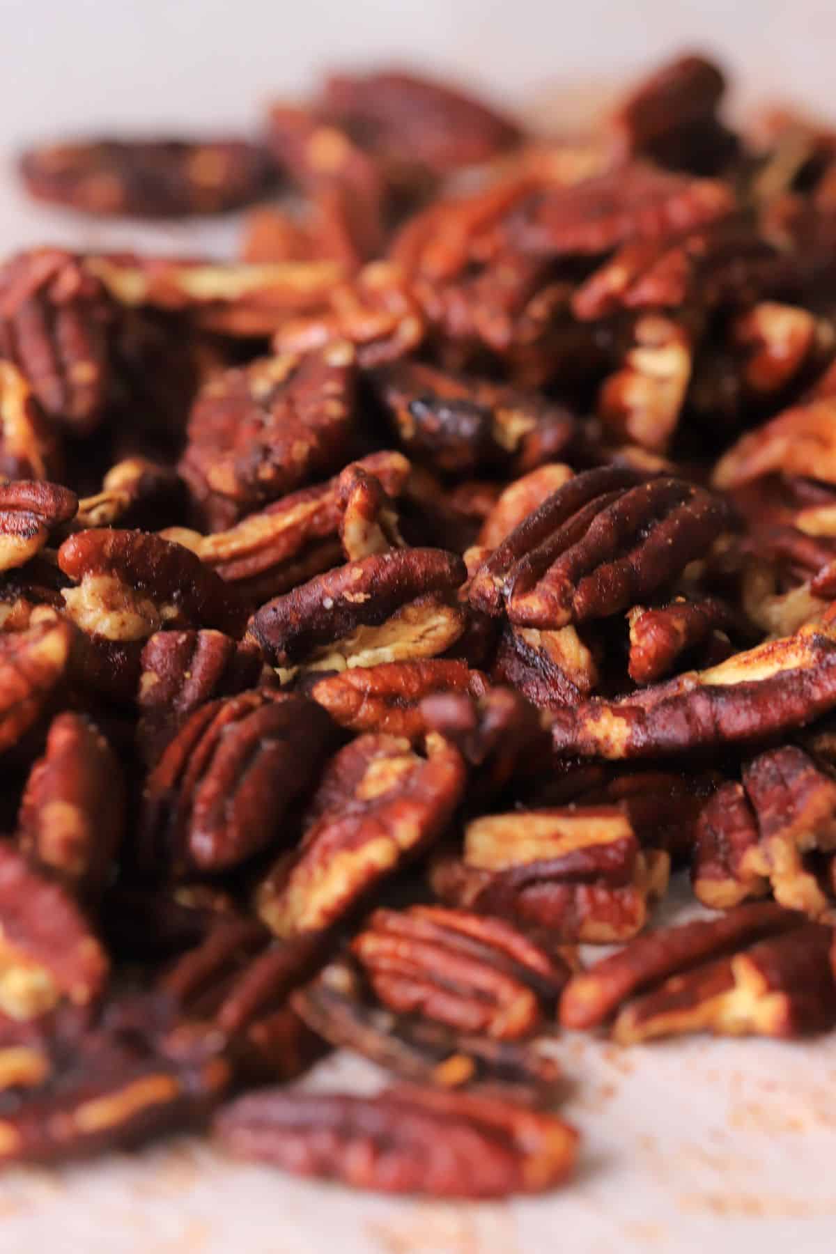 Low carb candied pecans on a baking sheet.