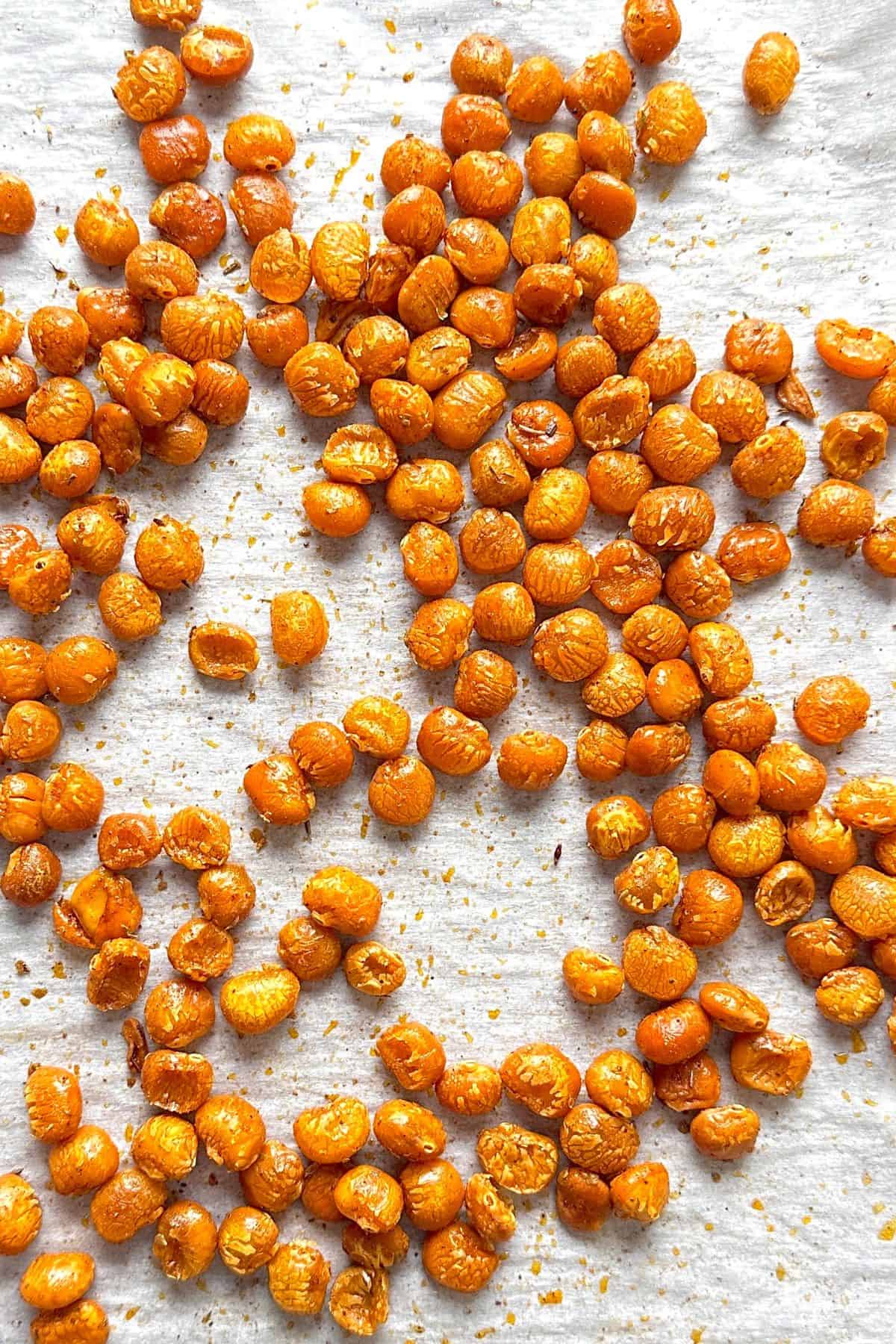 Low carb roasted lupini beans on a parchment lined baking sheet.