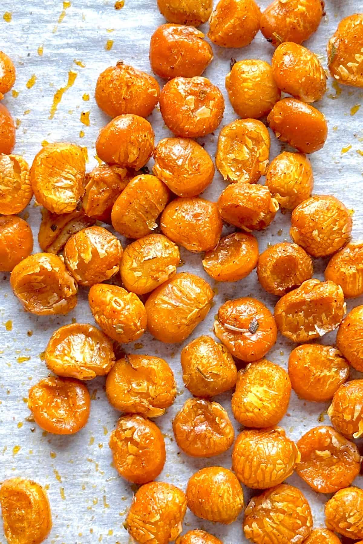 Low carb roasted lupini beans on a parchment lined baking sheet.