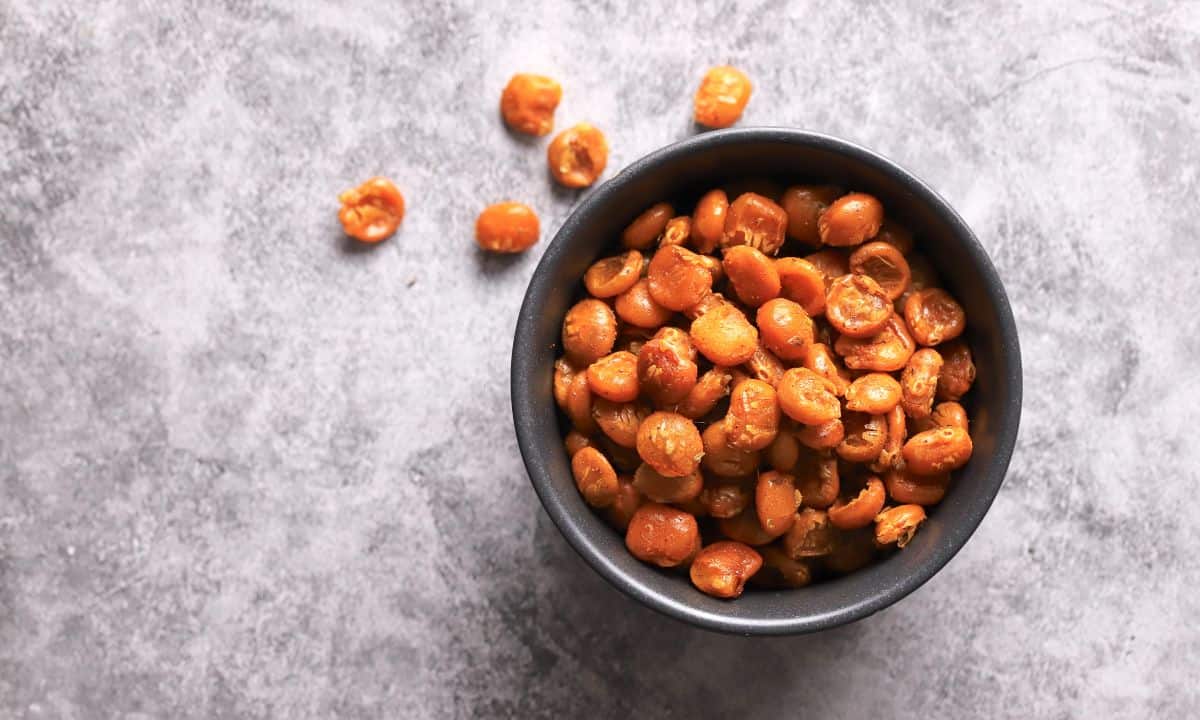 Low carb roasted lupini beans in a black bowl.