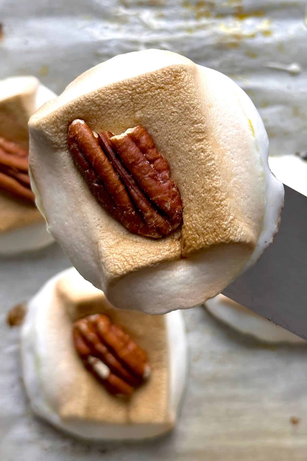 Close up of a low carb sweet potato bite with others in the background on a baking tray.