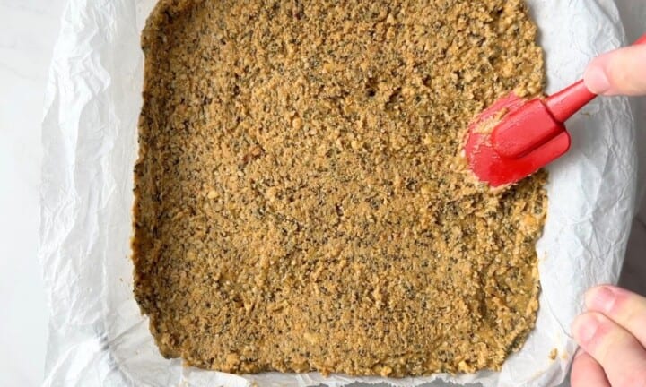 Spreading the mixture into the baking dish.