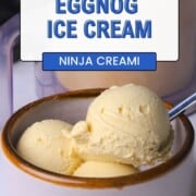 Sugar free eggnog ice cream in a bowl next to the ninja creami container.