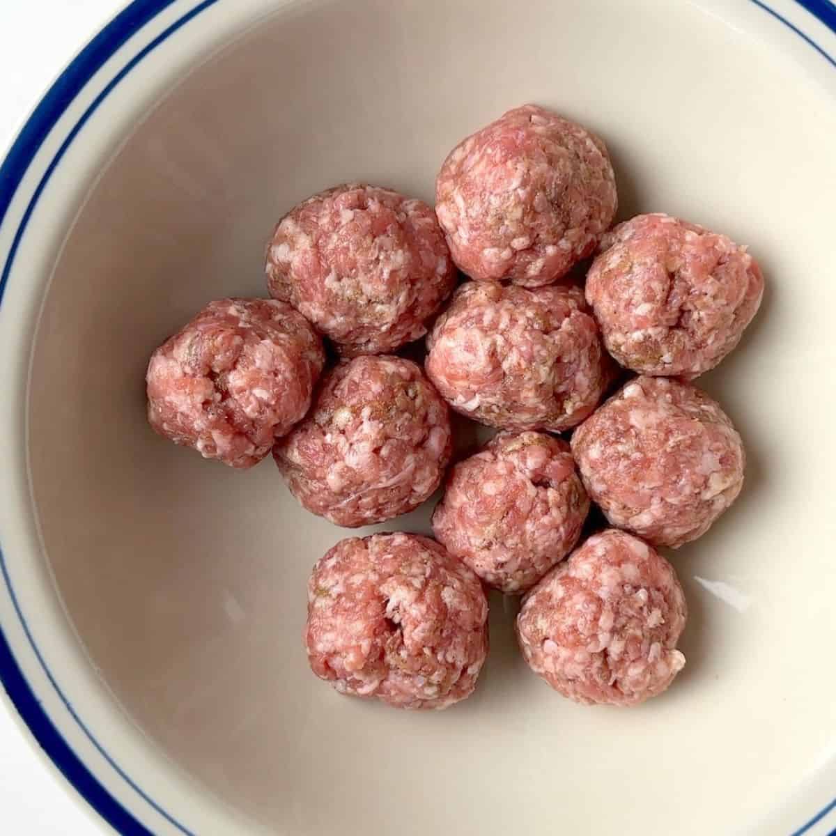 Balls of rolled sausage in a large bowl.