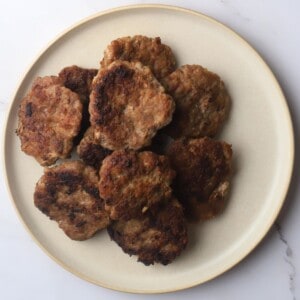 Carnivore breakfast sausage patties piled on a plate.