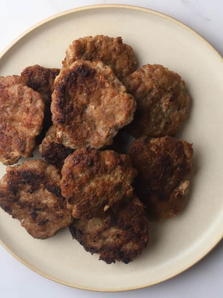 Carnivore breakfast sausage patties piled on a plate.