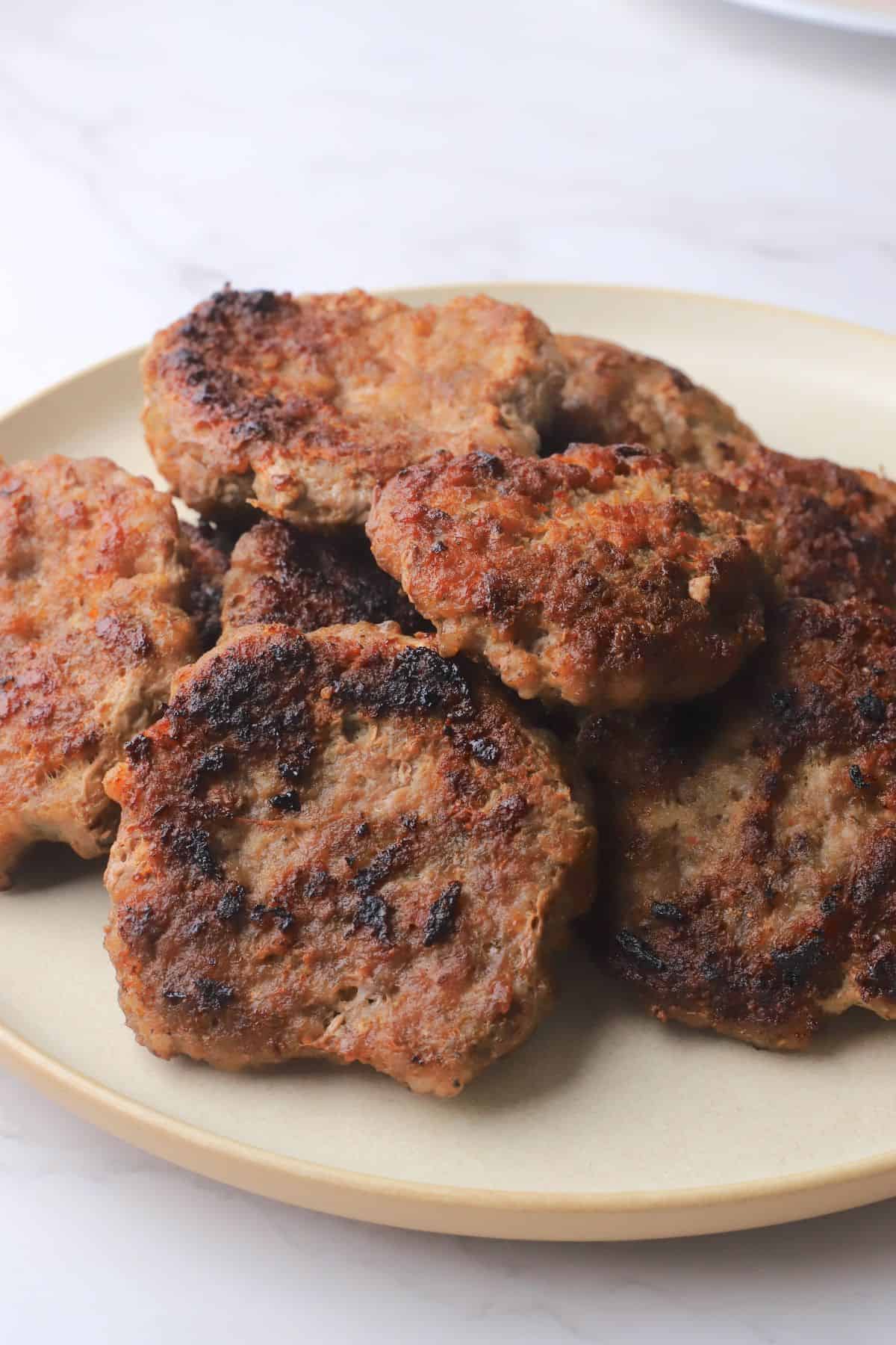 Carnivore breakfast sausage patties piled on a plate.