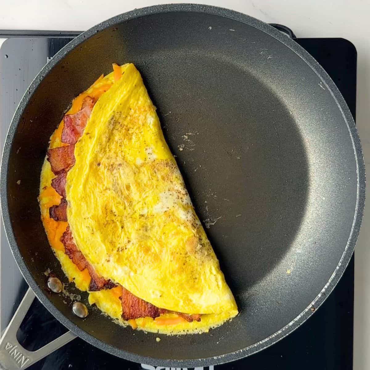 A folded omelette in a skillet.