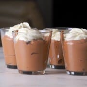 Protein mousse in glass containers topped with whipped cream.