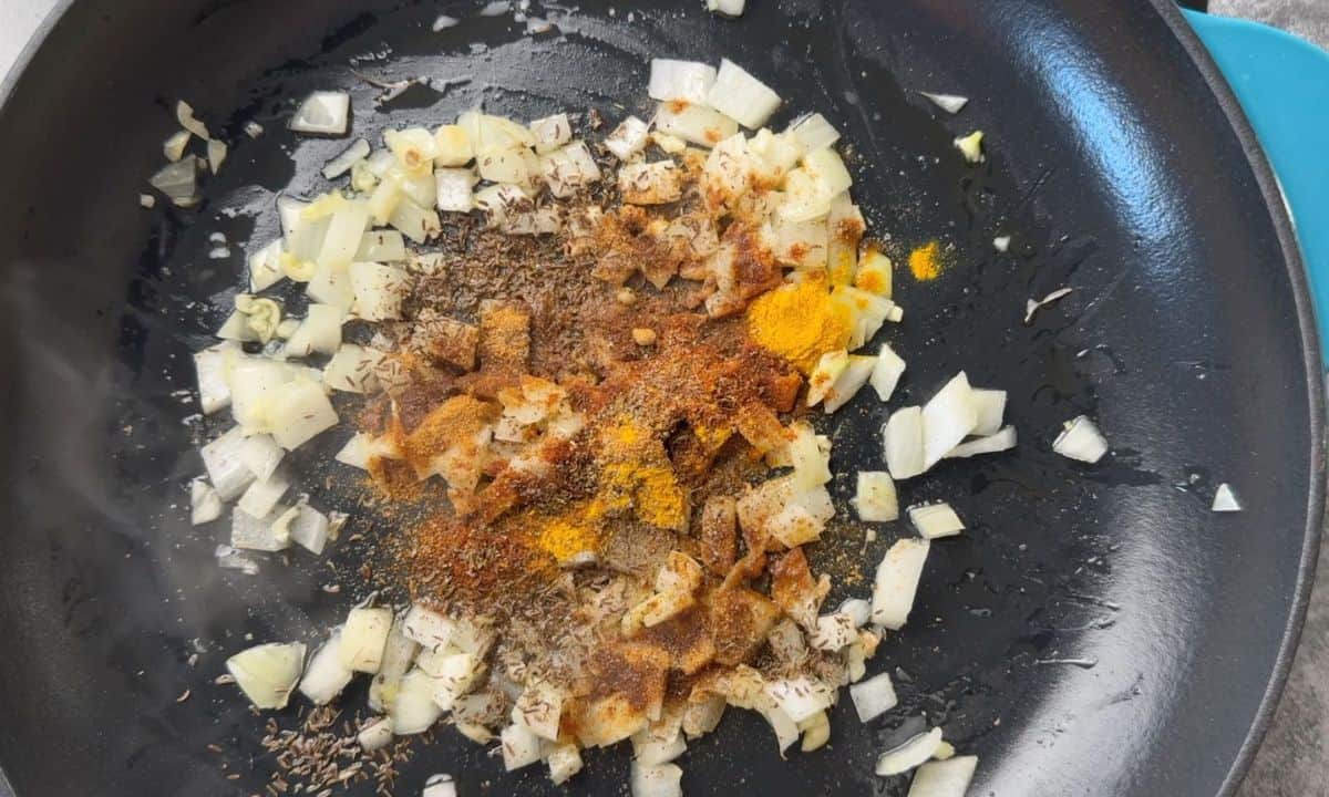 frying spices and onions in the skillet.