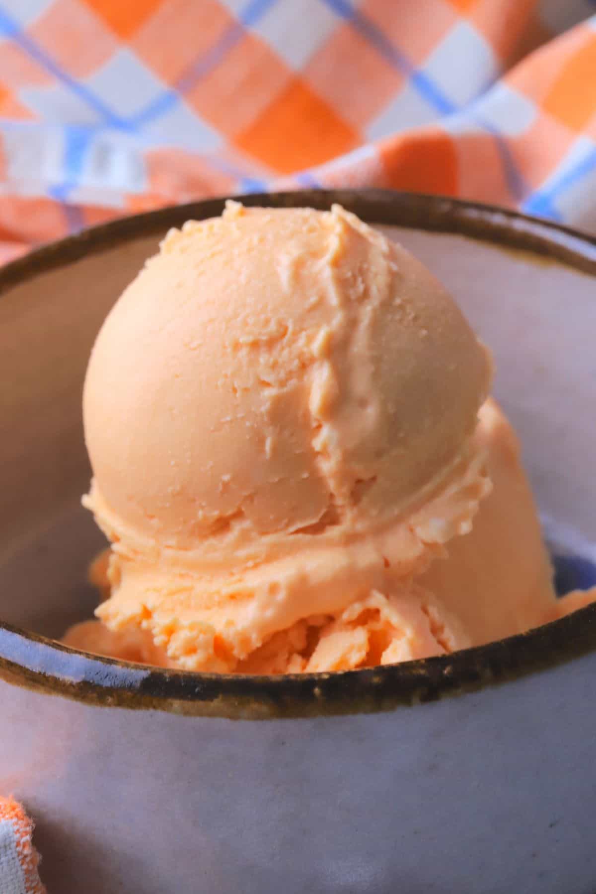 A bowl of sugar free orange creamsicle ice cream.