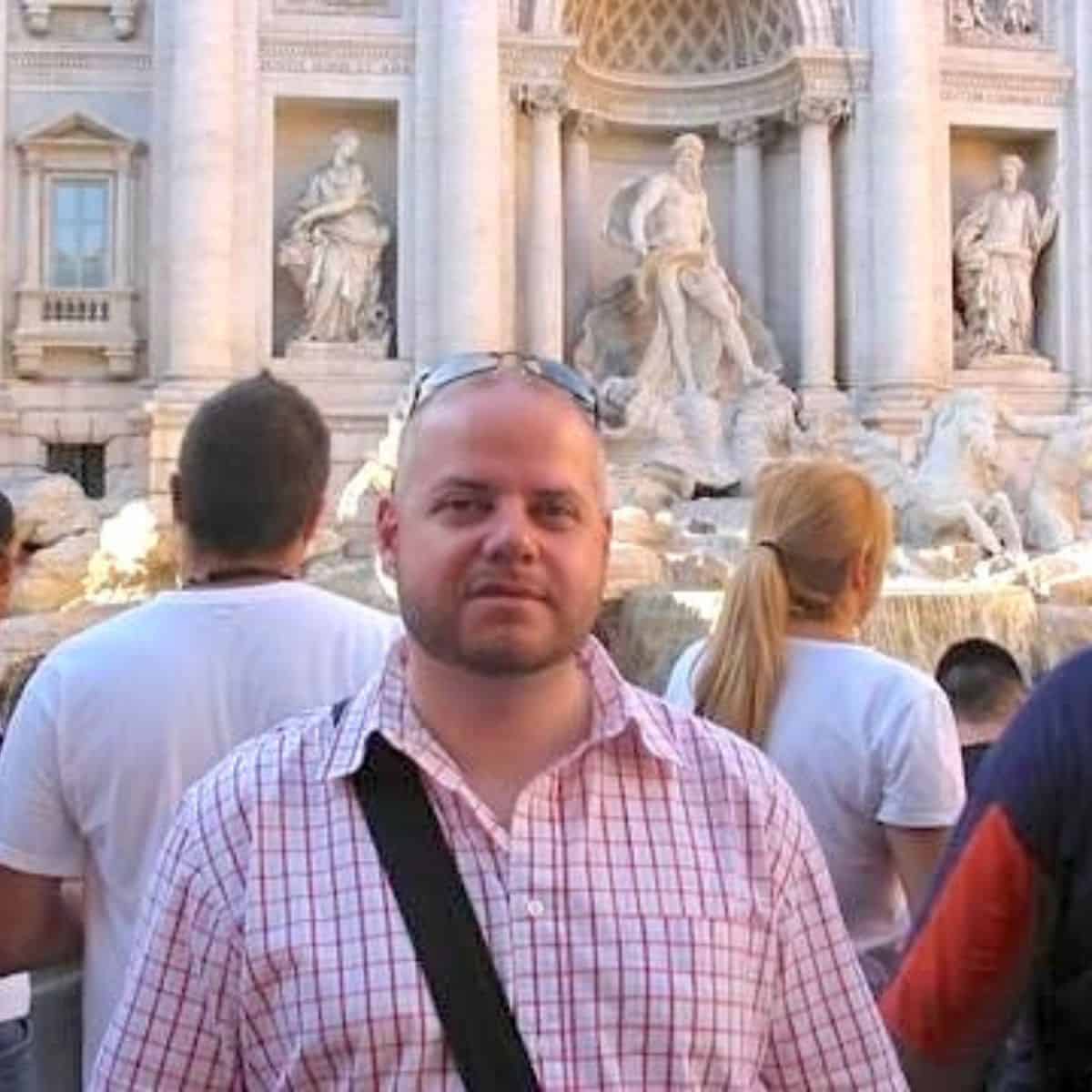 A photo of Oscar with the Trevi Fountain in the background.