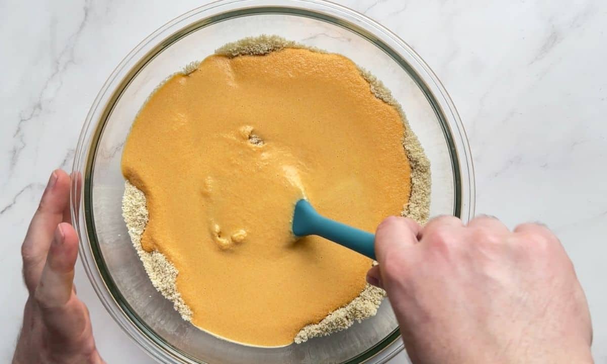 Combining the wet and dry ingredients in the bowl.