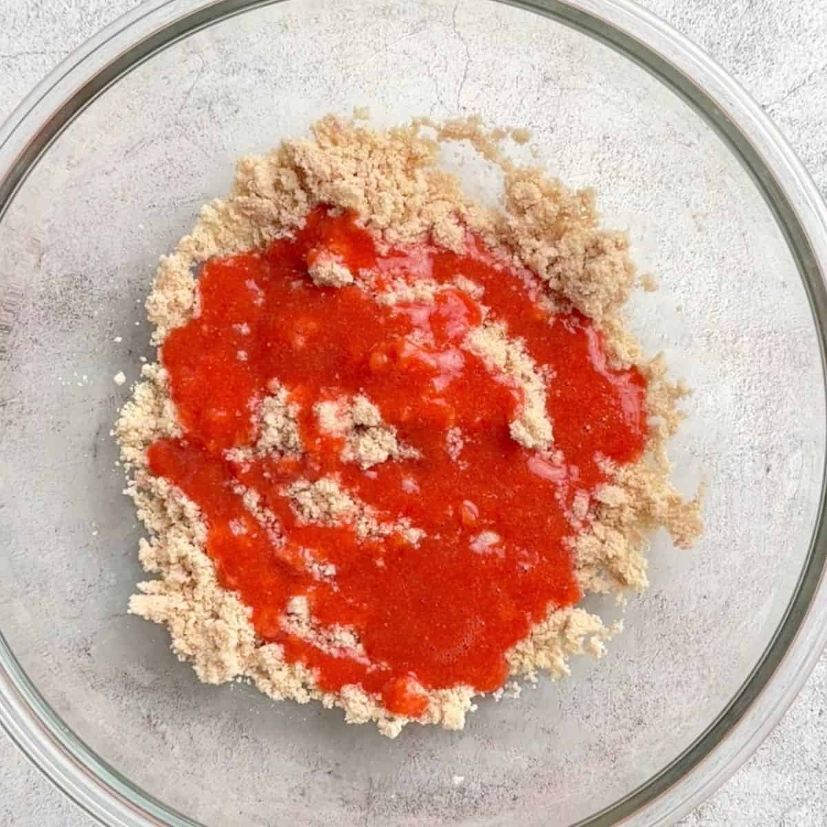 Almond flour mixture in a bowl topped with the strawberry mixture.