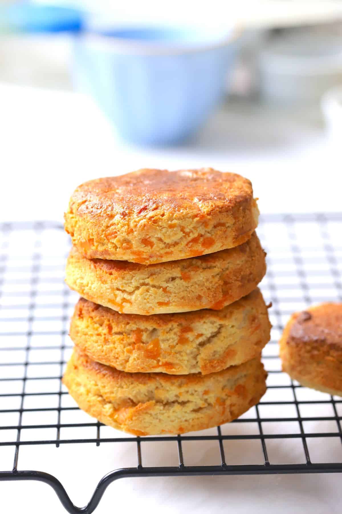 Four air fryer scones stacked on a cooling rack.