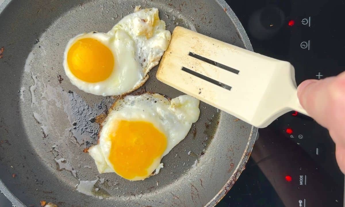 Two eggs frying in a pan.