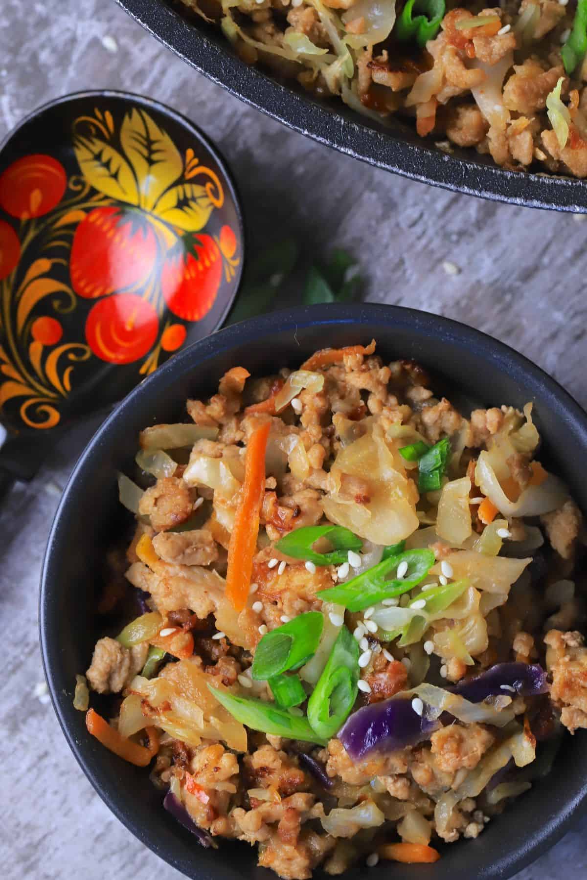 Low carb thai eggroll in a bowl in a large bowl next to a spoon.