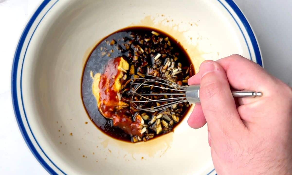 Whisking the sticky low carb sauce in a large bowl.