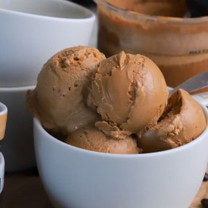 Coffee cups with scoops of the ninja creami sugar free coffee ice cream and a spoon.