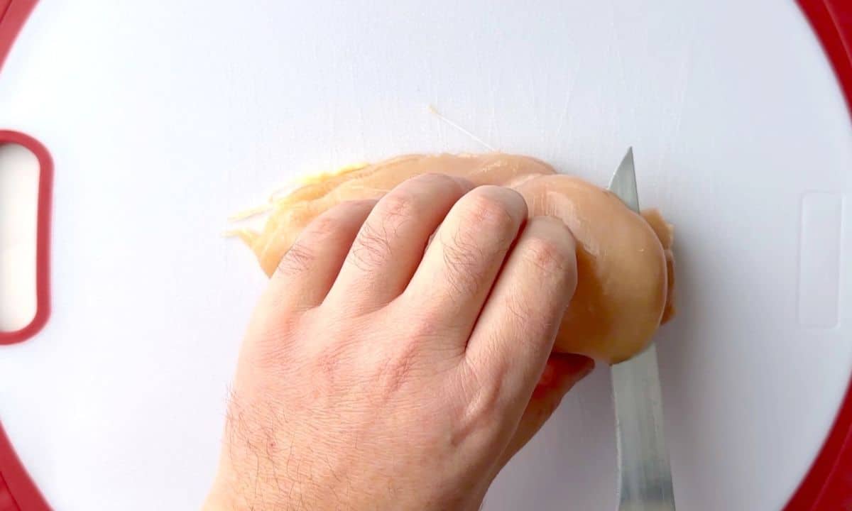 Slicing the chicken lengthwise in half.