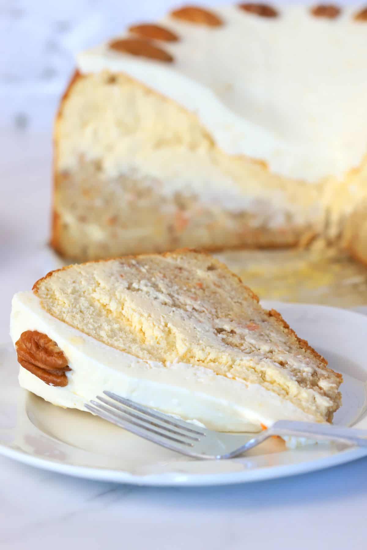 A slice of sugar free carrot cake decorated with cream cheese frosting.