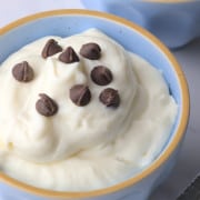 White chocolate mousse in blue bowl topped with sugar free chocolate chips.