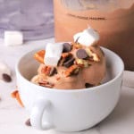 Sugar free rocky road ice cream in a bowl next to the ninja creami pint.