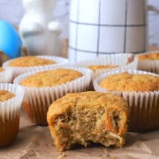 Closeup of Sugar-Free Carrot Cake Muffins one with a bite in it.