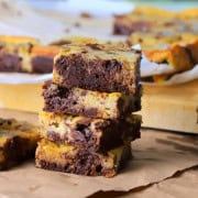 Sugar free banana pudding brownies stacked on top of each other. With more brownies in the background.