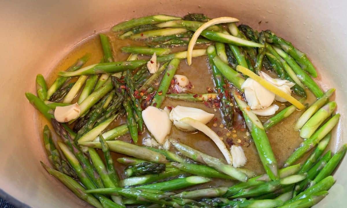 Sauteeing the asparagus with garlic, lemon rind and chili pepper flakes.