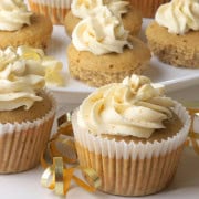 Low carb eggnog cupcakes on a white background with a gold ribbon.