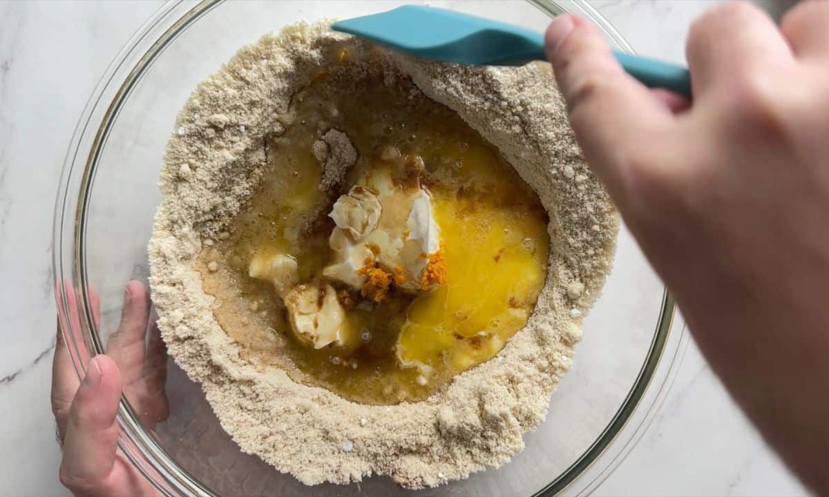 Adding the wet ingredients to the dry ingredients.