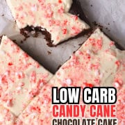 Low carb candy cane chocolate cake squares on a parchment paper, with one bite taked out of one of the squares.