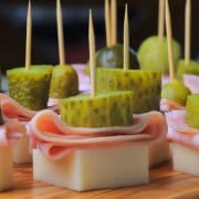 Low carb cuban sandwich skewers on a wooden cutting board.