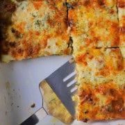 Low carb frittata in the casserole dish with a spatula.