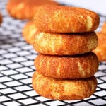 Low carb sugar free snickerdoodle cookies stacked on top of each other with other cookies behind it.