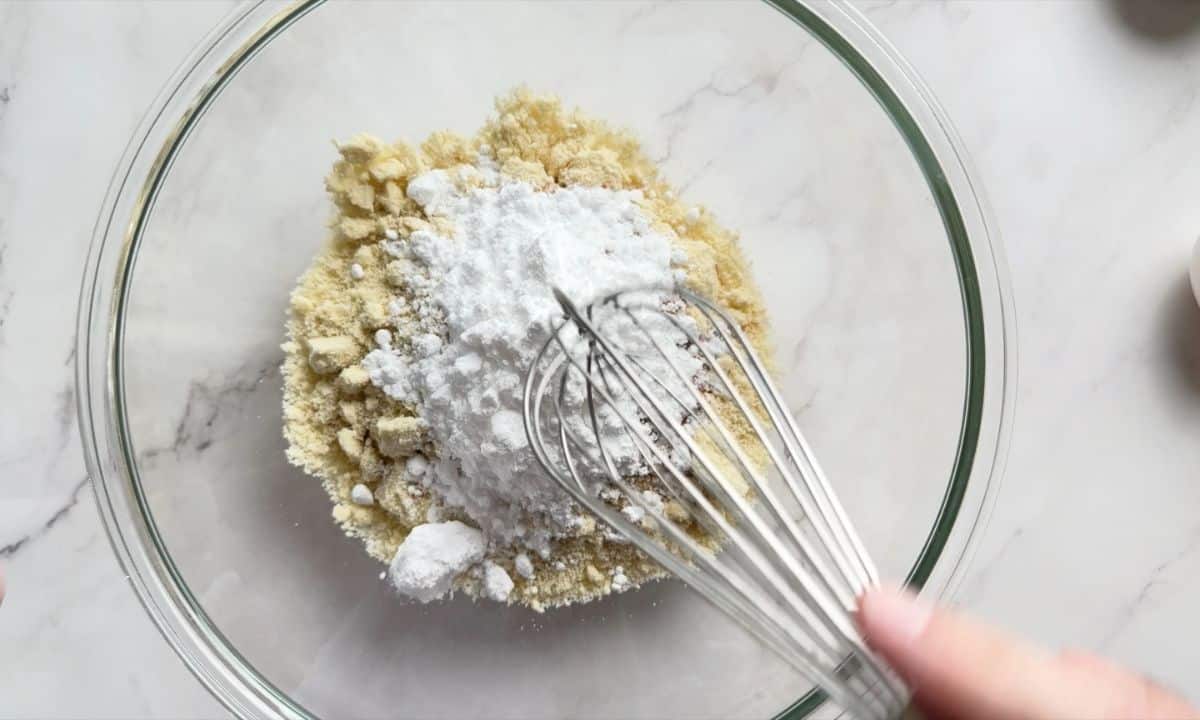 Mixing the dry ingredients with a whisk in a large glass bowl.