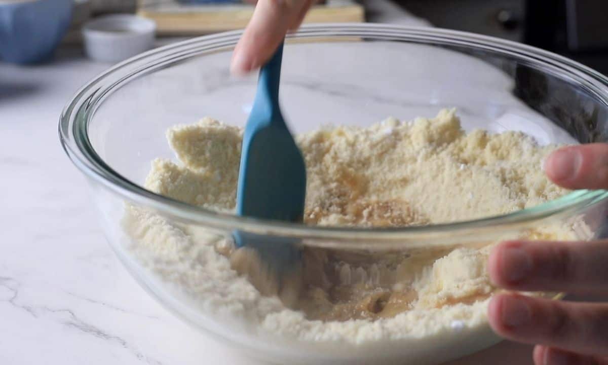 Mixing the wet and dry ingredients.